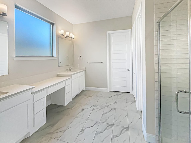 full bath with a stall shower, vanity, marble finish floor, and baseboards