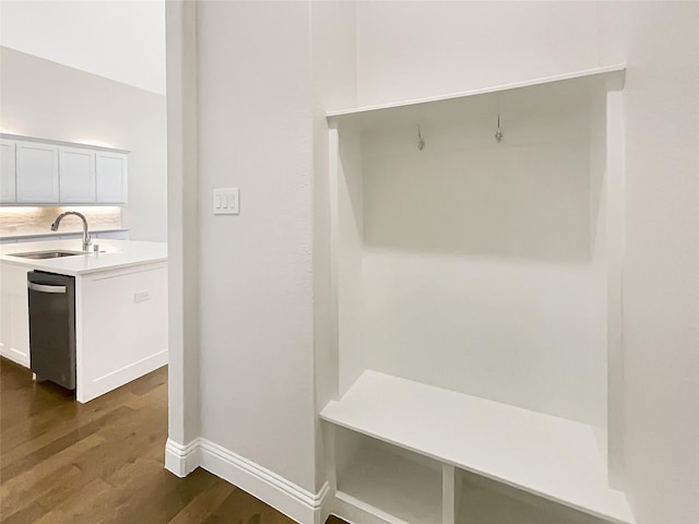 mudroom featuring baseboards, dark wood-style flooring, and a sink