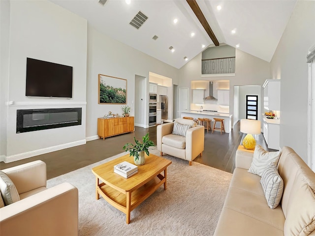 living area with visible vents, baseboards, recessed lighting, beam ceiling, and high vaulted ceiling