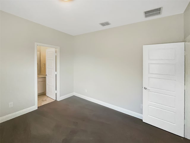 unfurnished bedroom featuring ensuite bathroom