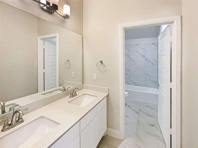 bathroom with marble finish floor, a sink, and baseboards