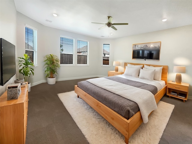 bedroom with ceiling fan and dark carpet