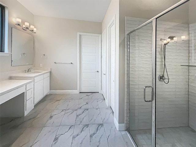 bathroom with a stall shower, marble finish floor, vanity, and baseboards