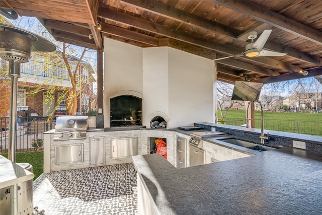 view of patio / terrace with ceiling fan, area for grilling, exterior kitchen, and sink