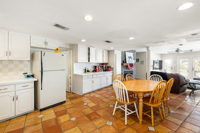 dining room with ceiling fan, light tile patterned floors, and a fireplace