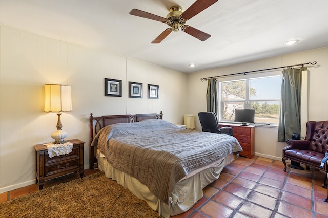 tiled bedroom featuring ceiling fan