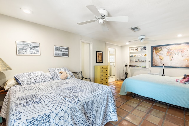 bedroom with ceiling fan and dark tile patterned floors