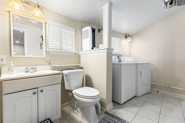 bathroom featuring vanity, washer and clothes dryer, toilet, and tile patterned flooring