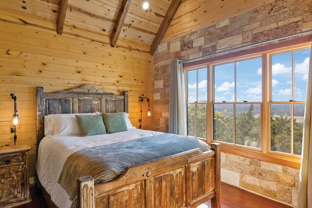 bedroom featuring vaulted ceiling with beams, wood ceiling, wooden walls, and dark wood-type flooring