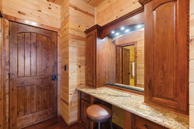 interior space with wooden walls and dark hardwood / wood-style flooring