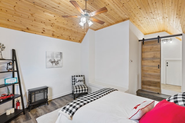 bedroom featuring wood ceiling, ceiling fan, a barn door, vaulted ceiling, and dark hardwood / wood-style floors