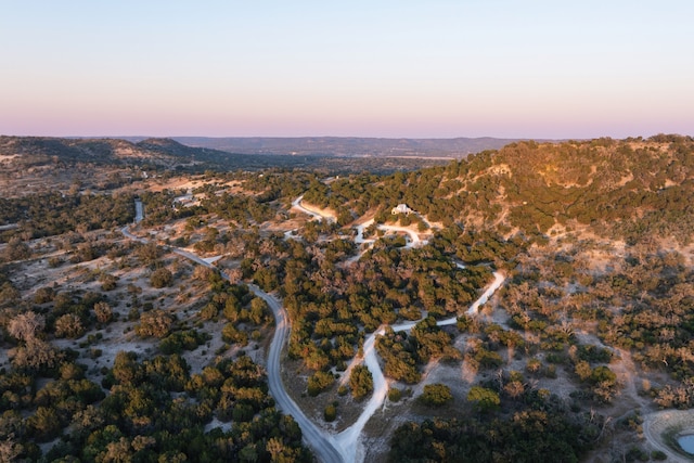 aerial view at dusk featuring a mountain view