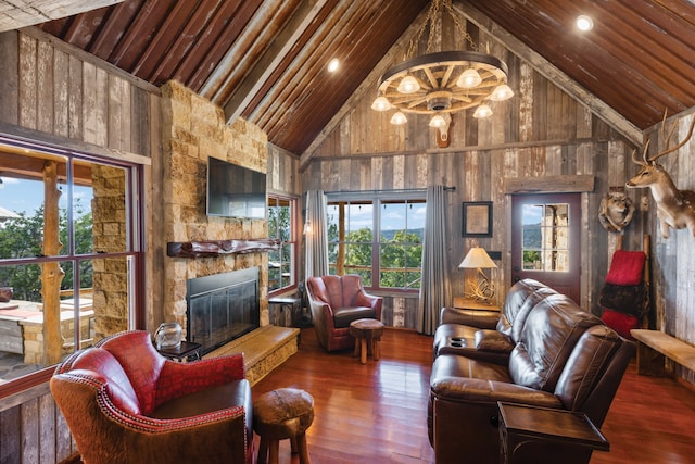 living room with a stone fireplace, wood walls, high vaulted ceiling, and dark hardwood / wood-style flooring