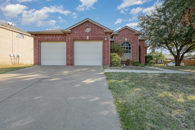 view of front facade with a front yard and a garage