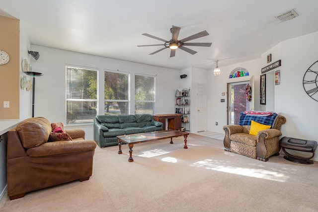 carpeted living room with ceiling fan