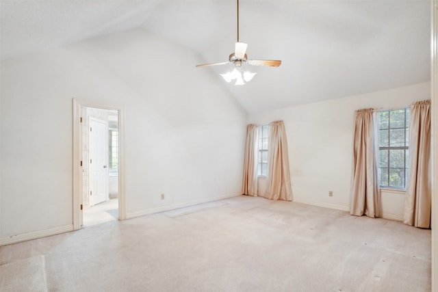 spare room with high vaulted ceiling, light colored carpet, and ceiling fan