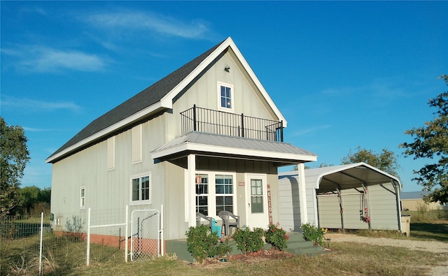 rear view of house with a balcony and a carport