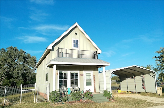 back of house with a carport and a balcony