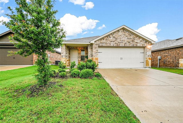 view of front of property with a front yard and a garage