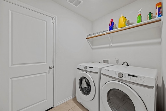 clothes washing area featuring independent washer and dryer and light tile patterned floors