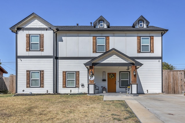 view of front facade with a front lawn and covered porch