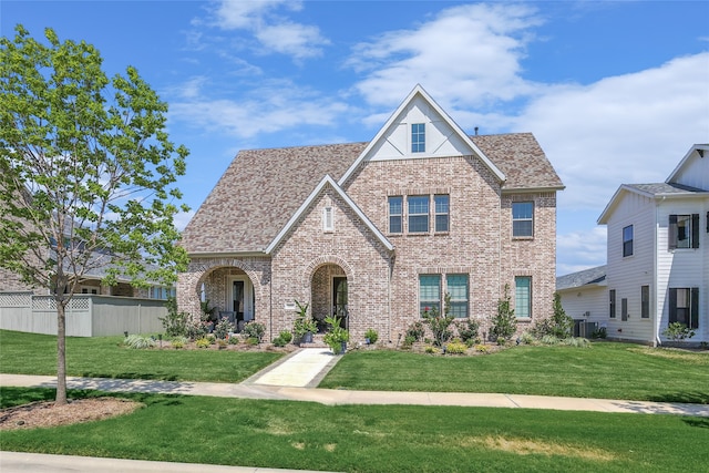 view of front of home featuring a front lawn and cooling unit