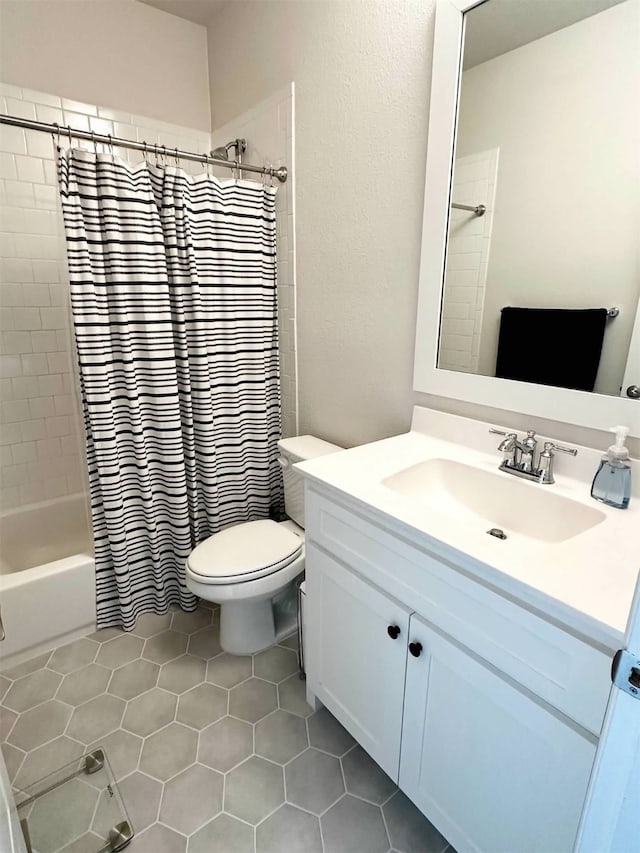 full bathroom with toilet, shower / tub combo, vanity, and tile patterned floors