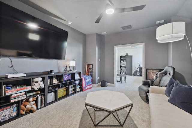 living room featuring ceiling fan and carpet