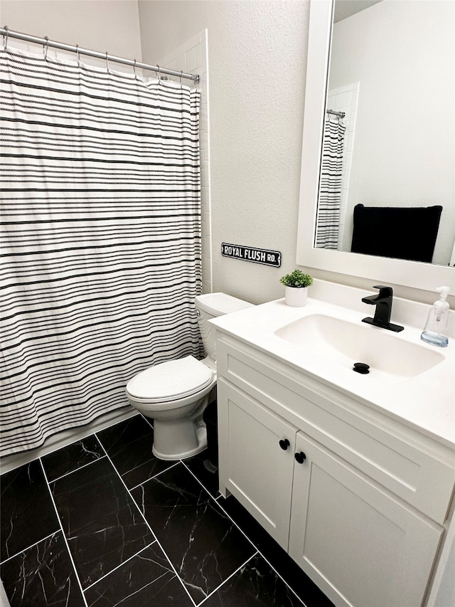 bathroom with vanity, toilet, and curtained shower