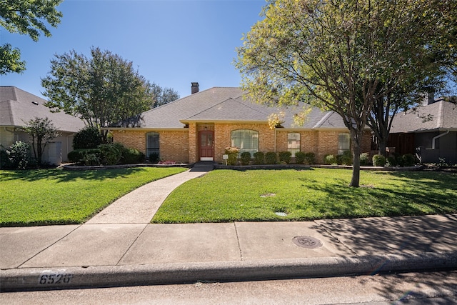 ranch-style house with a front lawn and a garage