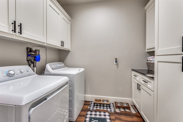 washroom featuring cabinets, washer and dryer, and dark hardwood / wood-style flooring