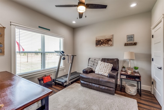 sitting room with ceiling fan and dark hardwood / wood-style flooring