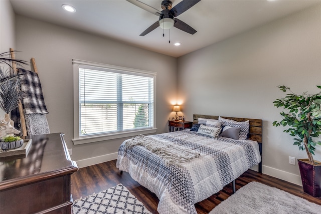 bedroom with ceiling fan and dark hardwood / wood-style floors