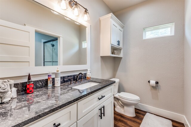 bathroom with vanity, toilet, and hardwood / wood-style flooring