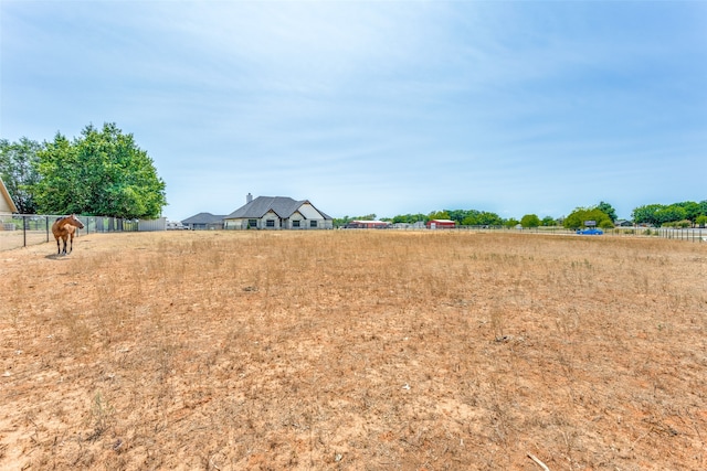 view of yard with a rural view