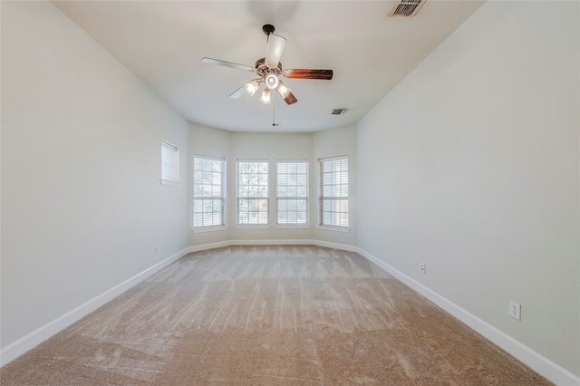 carpeted empty room featuring ceiling fan