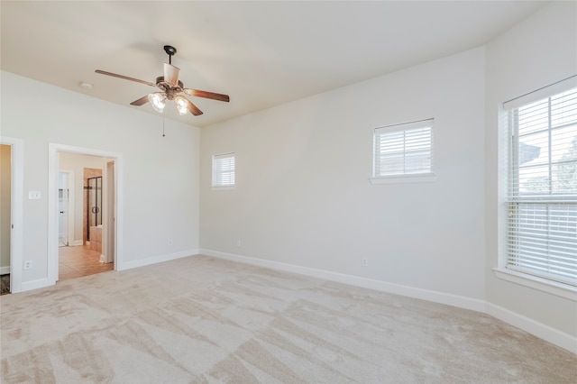 spare room with light carpet and ceiling fan