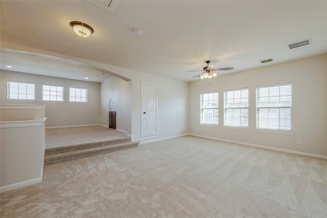 carpeted spare room featuring ceiling fan