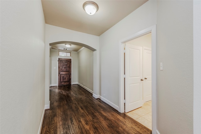 hall with ornamental molding and dark hardwood / wood-style floors