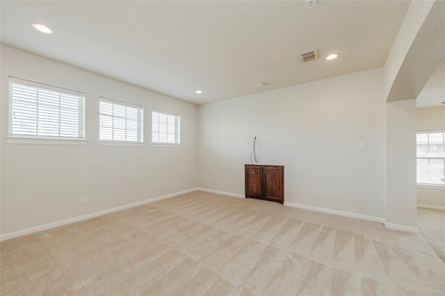 unfurnished room with light colored carpet