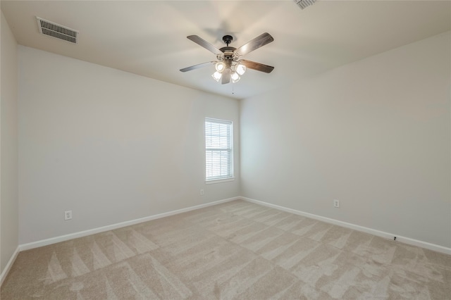 spare room with light carpet and ceiling fan