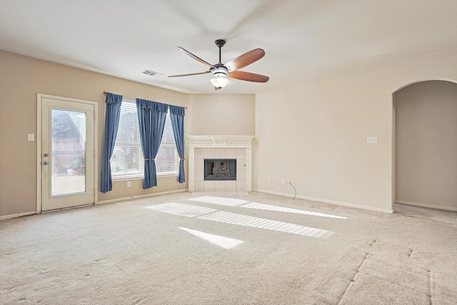 unfurnished living room featuring light carpet, a fireplace, and ceiling fan