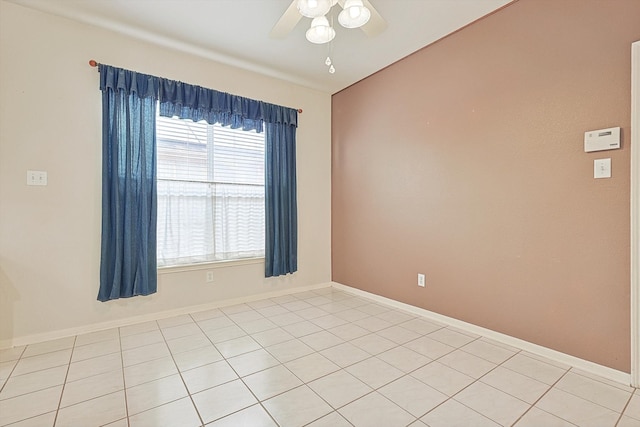 tiled spare room with ceiling fan