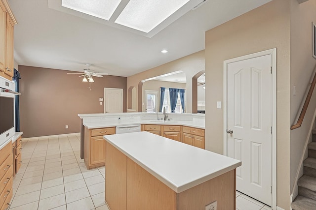 kitchen with a kitchen island, white dishwasher, kitchen peninsula, ceiling fan, and light brown cabinets