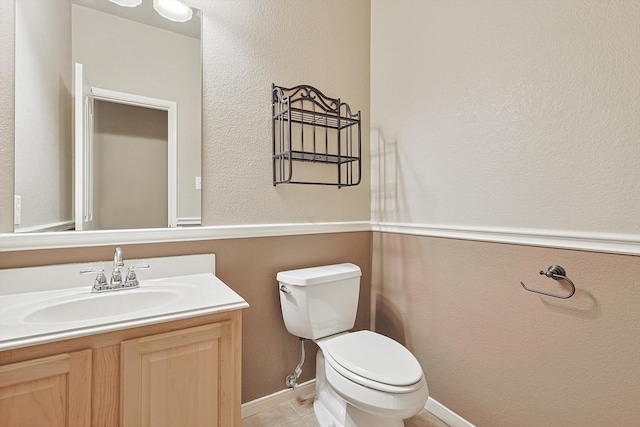 bathroom featuring vanity, toilet, and tile patterned floors