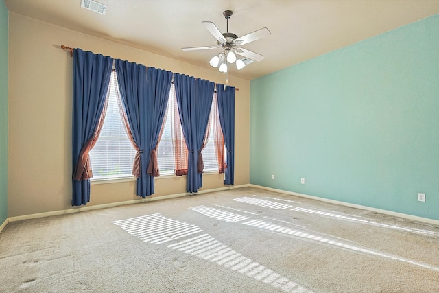 carpeted spare room with ceiling fan