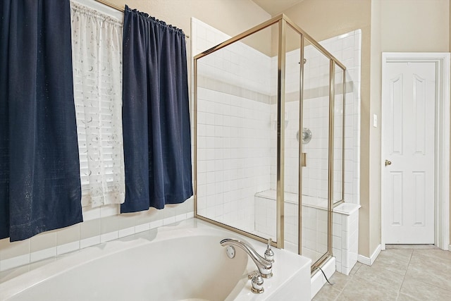 bathroom with independent shower and bath and tile patterned flooring