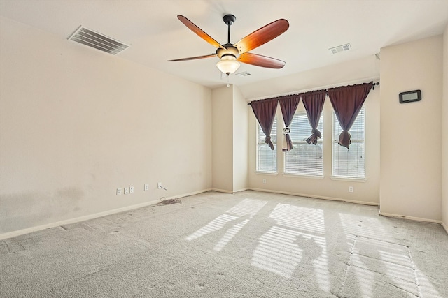 spare room featuring light carpet and ceiling fan