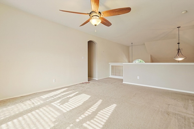 carpeted empty room with ceiling fan and lofted ceiling