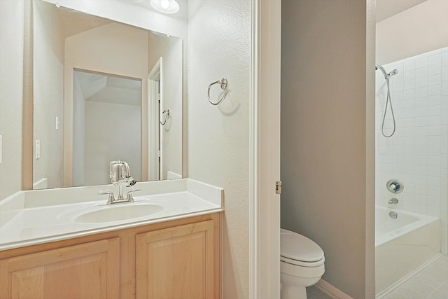 full bathroom with vanity, tiled shower / bath combo, and toilet